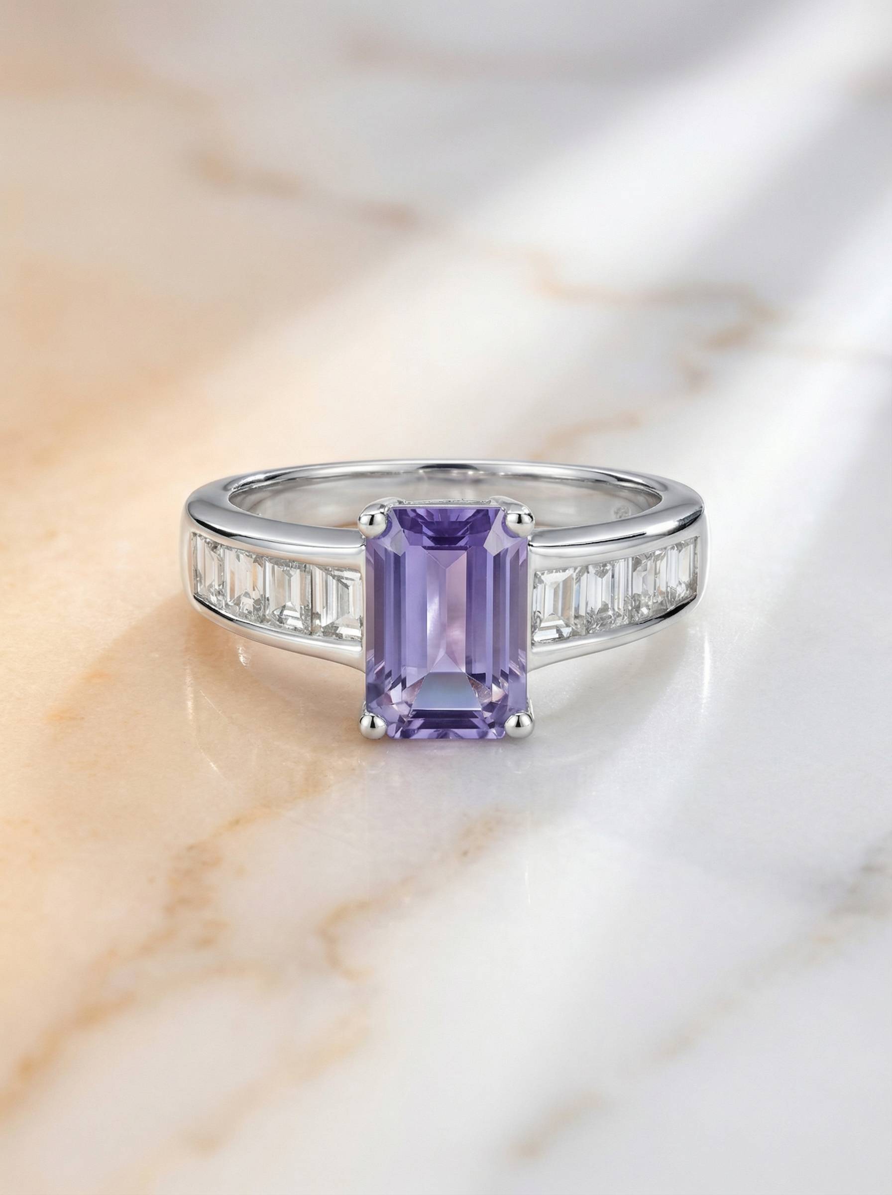 Emerald cut tanzanite ring with baguette diamond shoulders